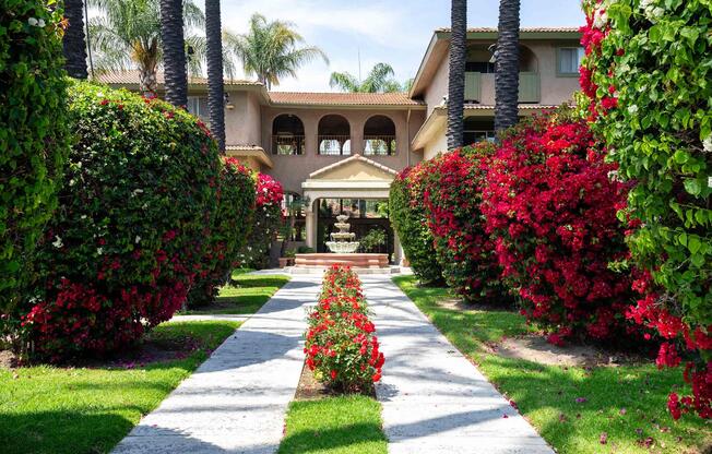 a close up of a flower garden in front of a house