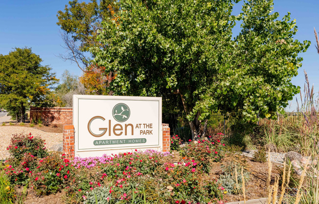 a sign for glen at the park in front of a tree