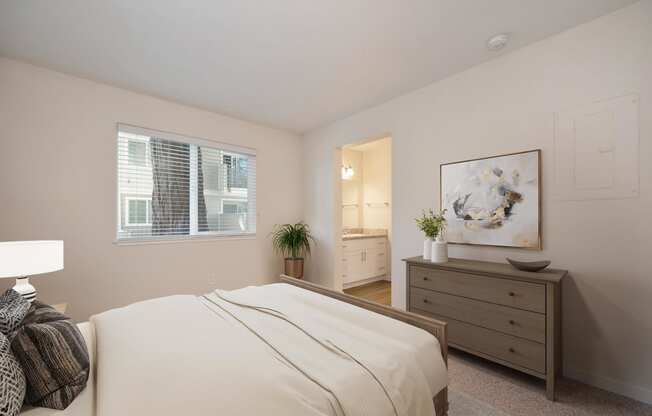 a bedroom with a bed and a dresser and a window at Rush River Apartments, Sacramento, CA