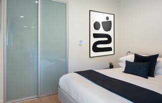 a bedroom with a bed and a glass door