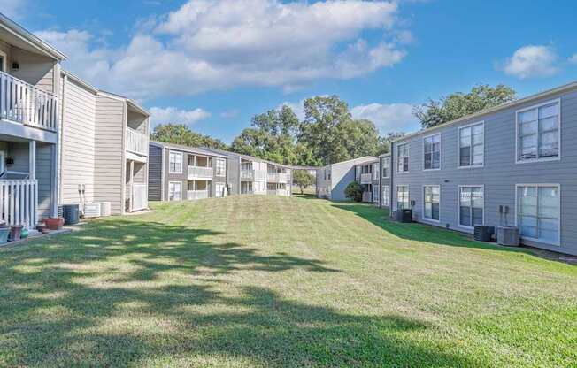 A sunny day showcasing our beautiful landscaping in the apartment complex at Maplewood apartments in Shreveport, LA.