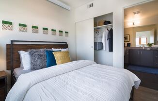 Portland, OR Apartments - Muse Apartments Bedroom With Stylish Decore, Large Closet and Access to Bathroom