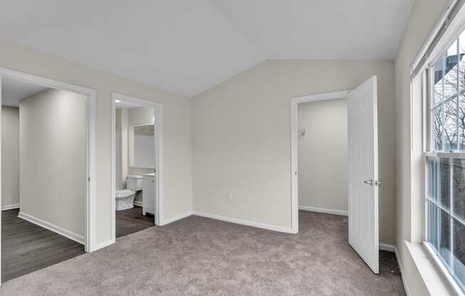 A room with a carpeted floor and white walls in the Loft at the Ledges Apartments.