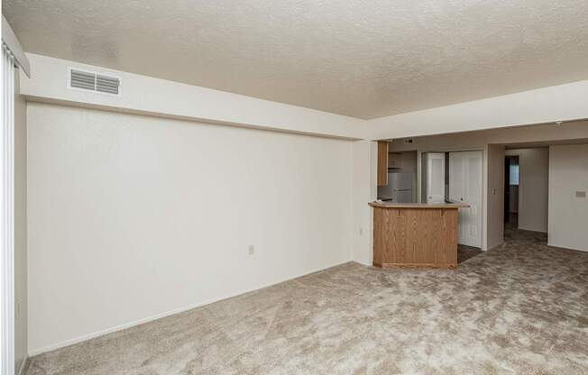 A room with a carpeted floor and a wooden cabinet.