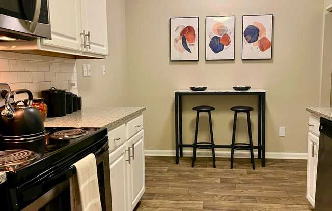 a kitchen with a counter and stools and a bar with two stools
