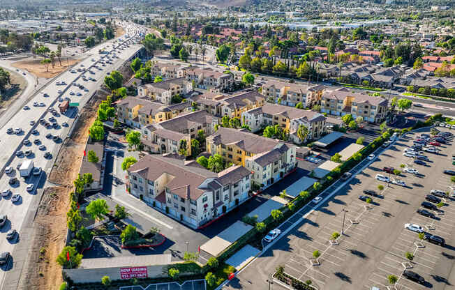 an aerial view of a city with cars on the street and buildings