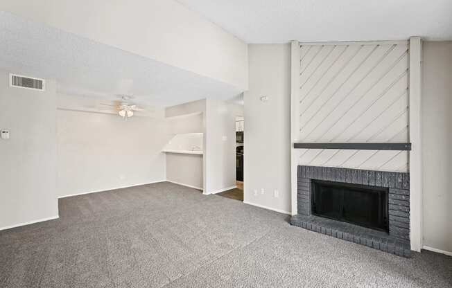 a living room with a fireplace and a ceiling fan