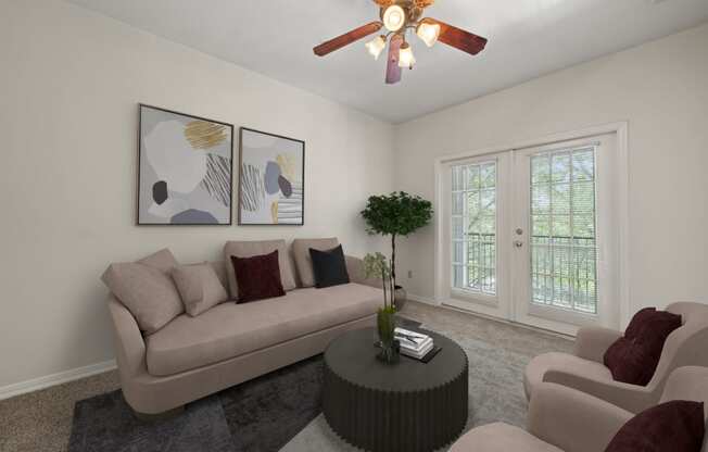 a living room with a couch and a coffee table and a ceiling fan