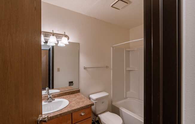 A bathroom with a sink toilet and shower. Fargo, ND Long Island Apartments.