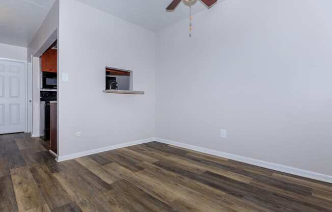 a living room with hardwood floors and a ceiling fan