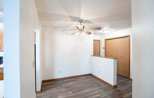 A room with a ceiling fan and a white wall. Fargo, ND Westwood Estates