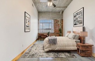 a bedroom with a large bed and a ceiling fan