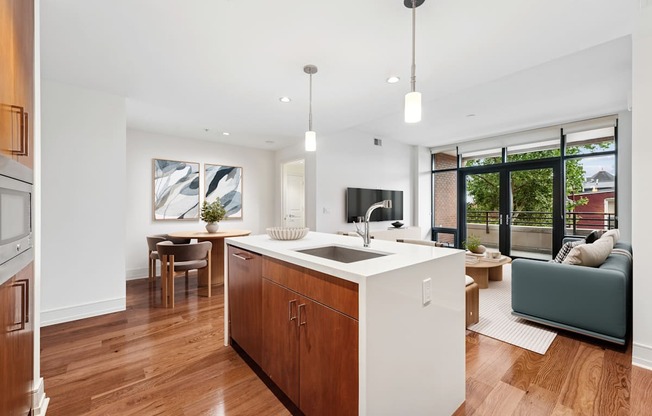 A modern kitchen with wooden floors and a large island.
