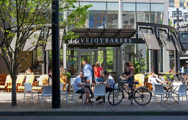 A bakery named Lovejoybakers has a patio with people sitting and eating.