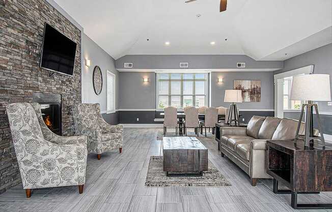 A community building with a fireplace and a television on the wall at The Reserve at The Reserve at Destination Pointe in Grimes, IA 50111