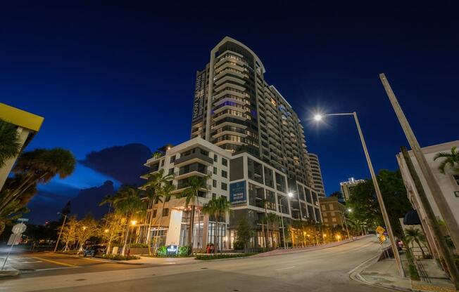 a city street at night with a tall building in the background at Regatta at New River, Fort Lauderdale Florida