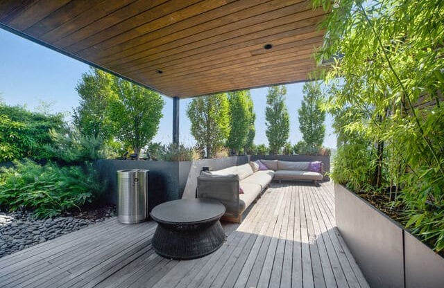 a patio with a couch and a table on a roof