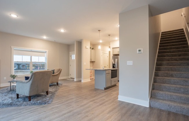 A living room with a staircase leading to the upper floor.