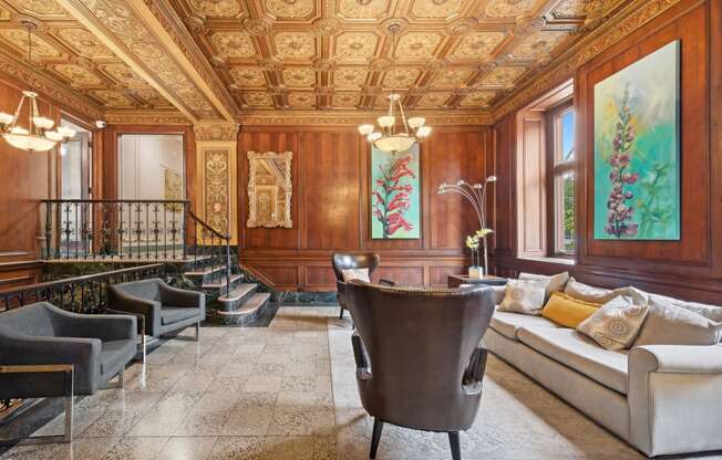 a living room with wood paneling and a seating area with a table and chairs