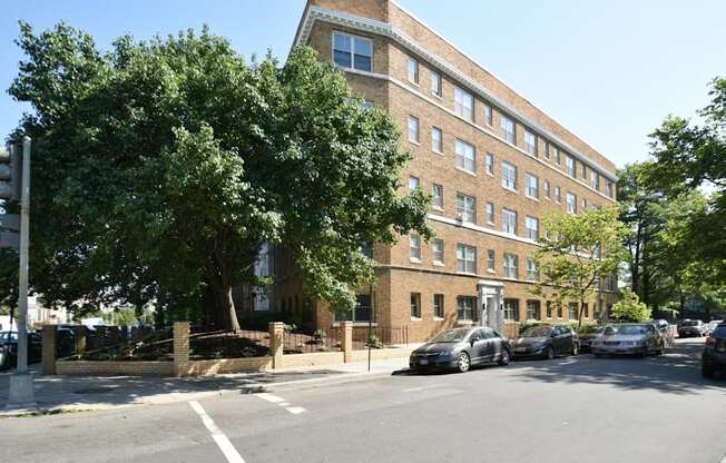 a large brick building with cars parked in front of it