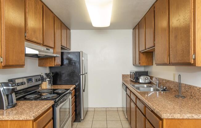 a kitchen with stainless steel appliances and wooden cabinets