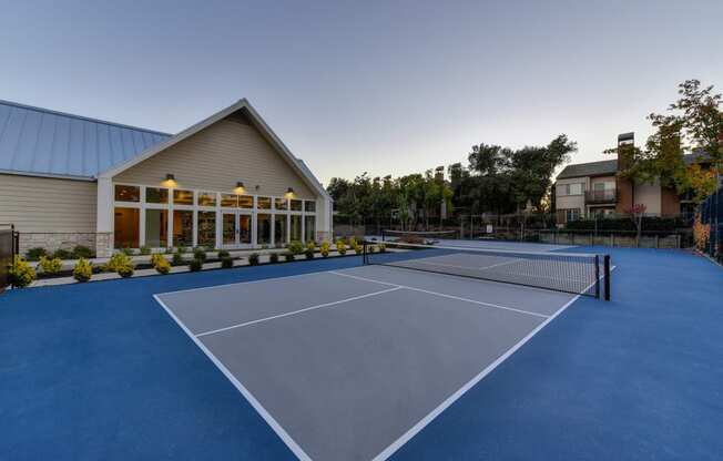 Several sport courts with Fitness Center in the surrounding building. Exterior is landscaped with mature Trees and bushes