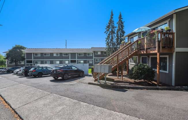 an apartment building with stairs and a parking lot