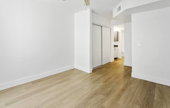 A room with a wooden floor and white walls.
