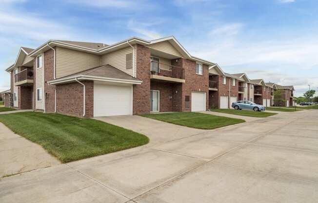 Exterior of Northbrook Apartments with attached garages and lawns
