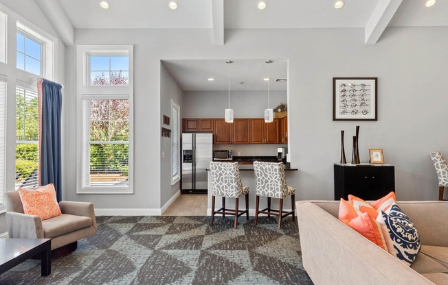 a living room with a kitchen and a dining room