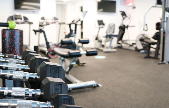 Open fitness center featuring full range fitness equipment at Westwood Riviera Apartments, Los Angeles, California