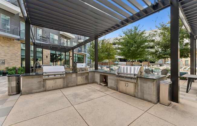 A patio with a table and chairs under a roof.