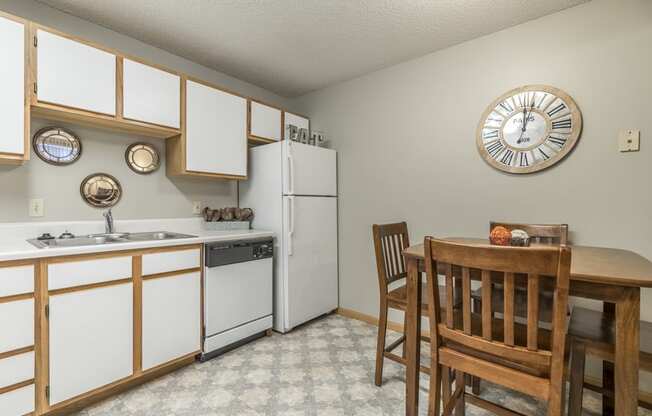 Traditional style kitchen with white cabinets and wooden trim