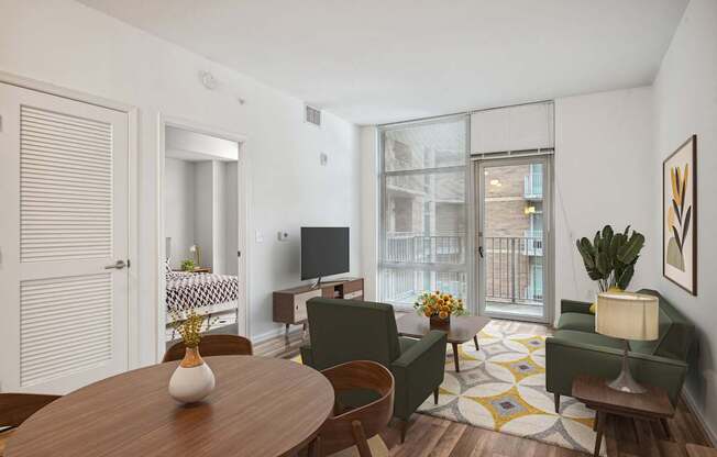 a living room with a table and chairs and a tv