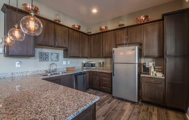 a kitchen with stainless steel appliances and granite counter tops