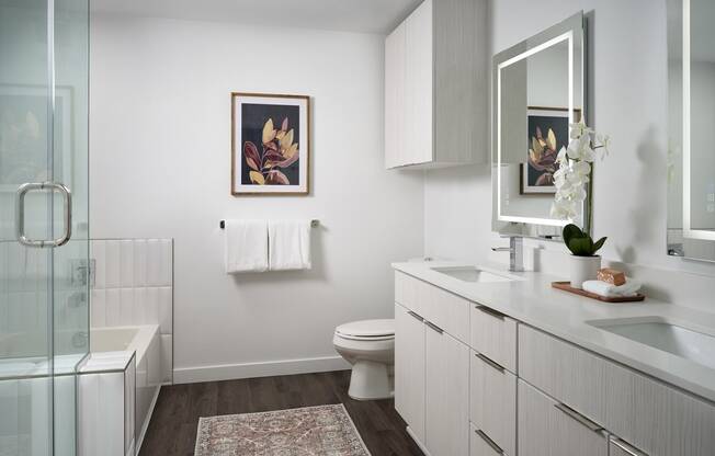 a bathroom with a toilet and a sink and a shower