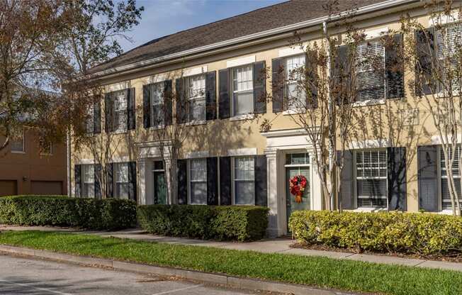 A building with a red wreath on the door.