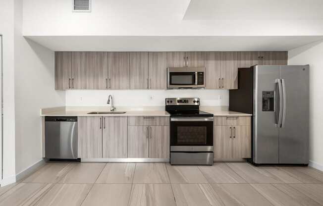 a kitchen with stainless steel appliances and wooden cabinets