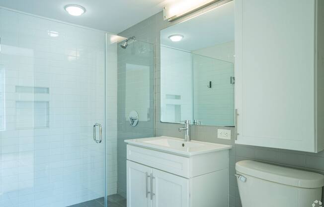 A white bathroom with a glass shower stall at 603 Concord Apartments, Cambridge, MA