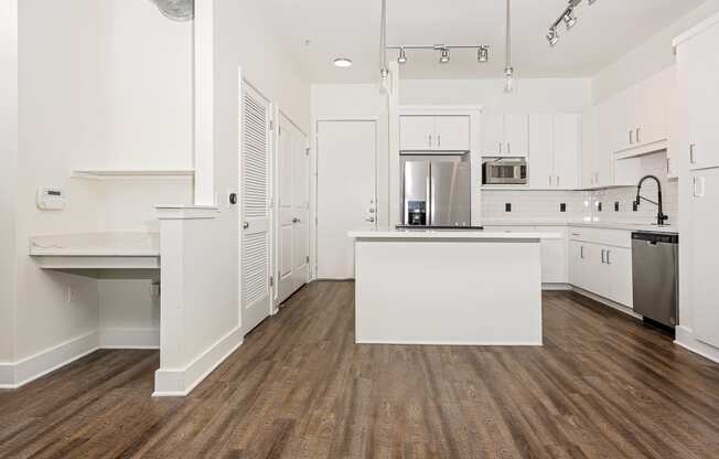 a kitchen with white cabinets and white countertops