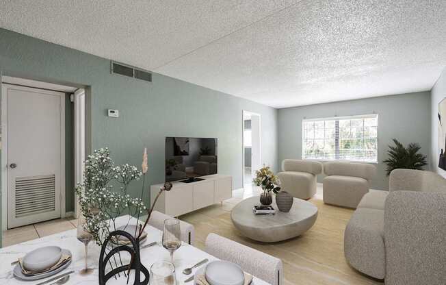A living room with a dining table set for two and a television.