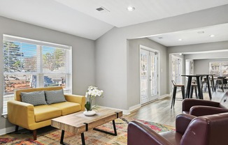 Living room with a yellow couch and a coffee table   and a kitchen  at Emerald Bay, North Carolina