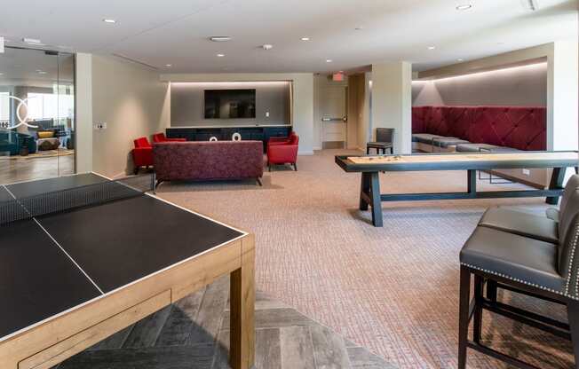 a game room with a ping pong table and couches