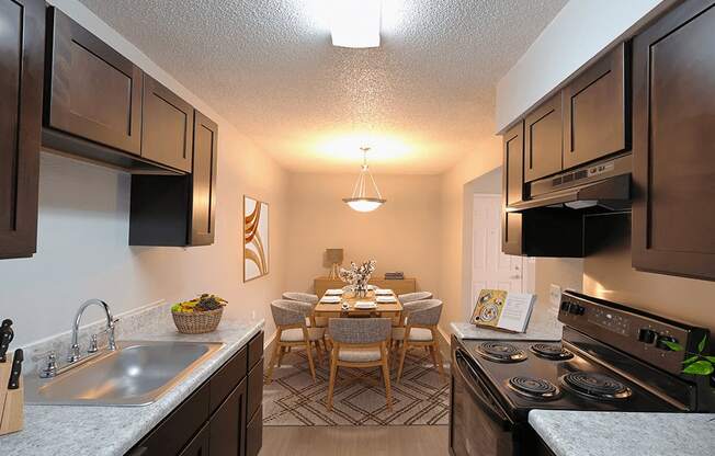full kitchen and dining room with stainless steel appliances and wood flooring