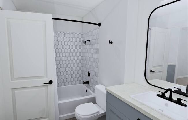 a white bathroom with a tub and a sink and a toilet