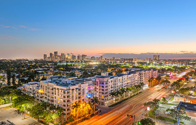 an aerial view of a city at sunset with traffic and buildings