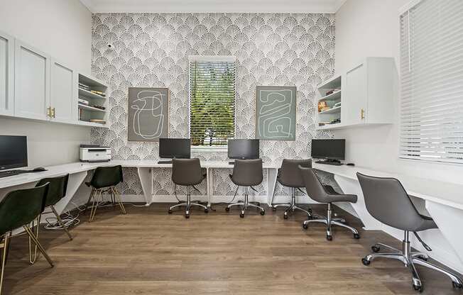 A white desk with a laptop and a printer on it.