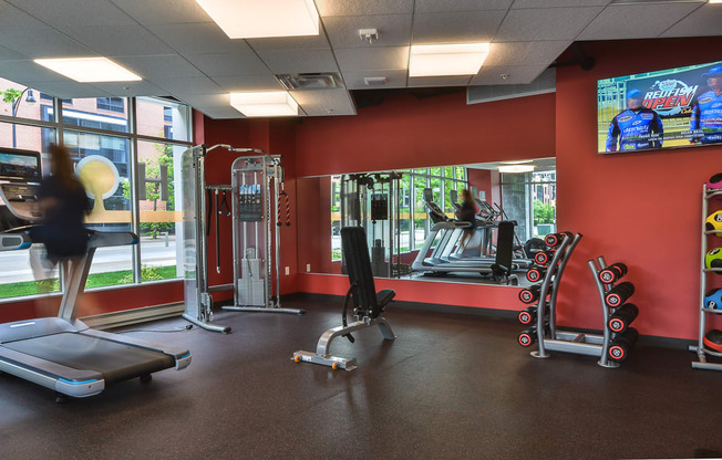 a fitness room with treadmills and other exercise equipment