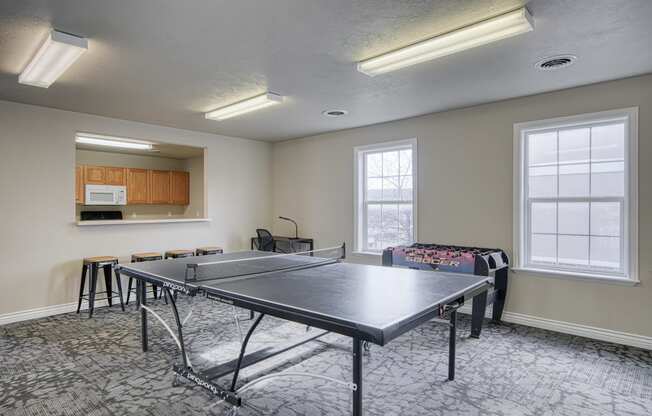 a room with a ping pong table and a couch
