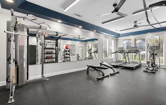 A spacious home gym with a variety of exercise equipment.